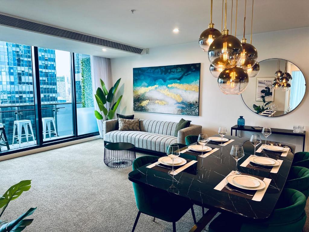 a living room with a couch and a table at Stylish Southbank apartment Plus Free Parking for 2 Cars in Melbourne