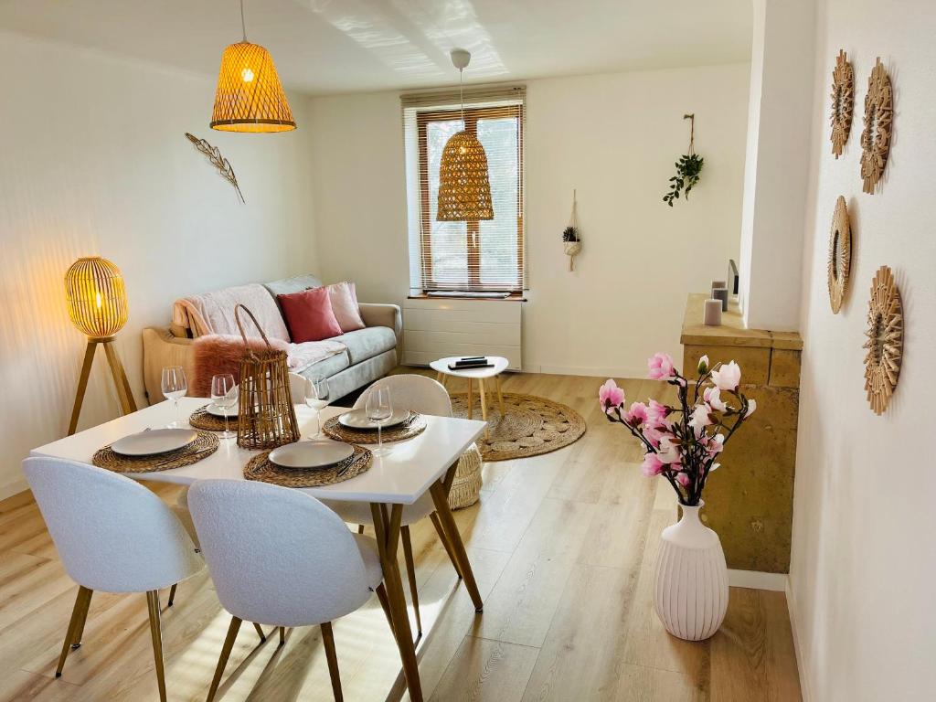 a living room with a white table and chairs at Le bohème 