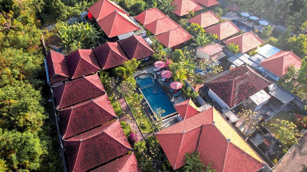 an overhead view of a group of houses with red roofs at Garden Cottage Lembongan & Hostel in Nusa Lembongan