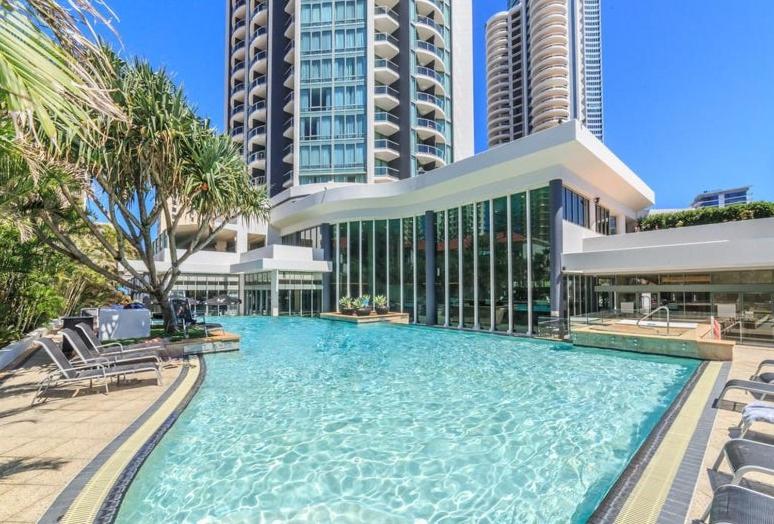 a large swimming pool in front of some buildings at LEGENDS HOTEL - hosted by Coastal Letting in Gold Coast