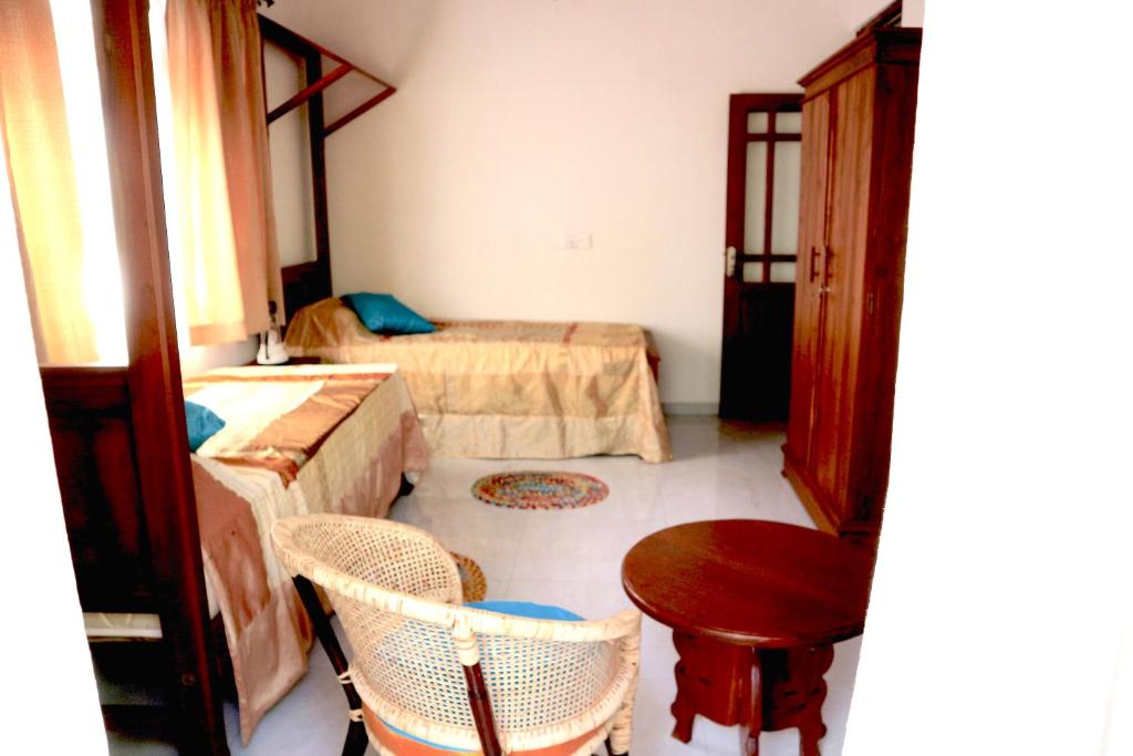 Postel nebo postele na pokoji v ubytování Mango Tree House
