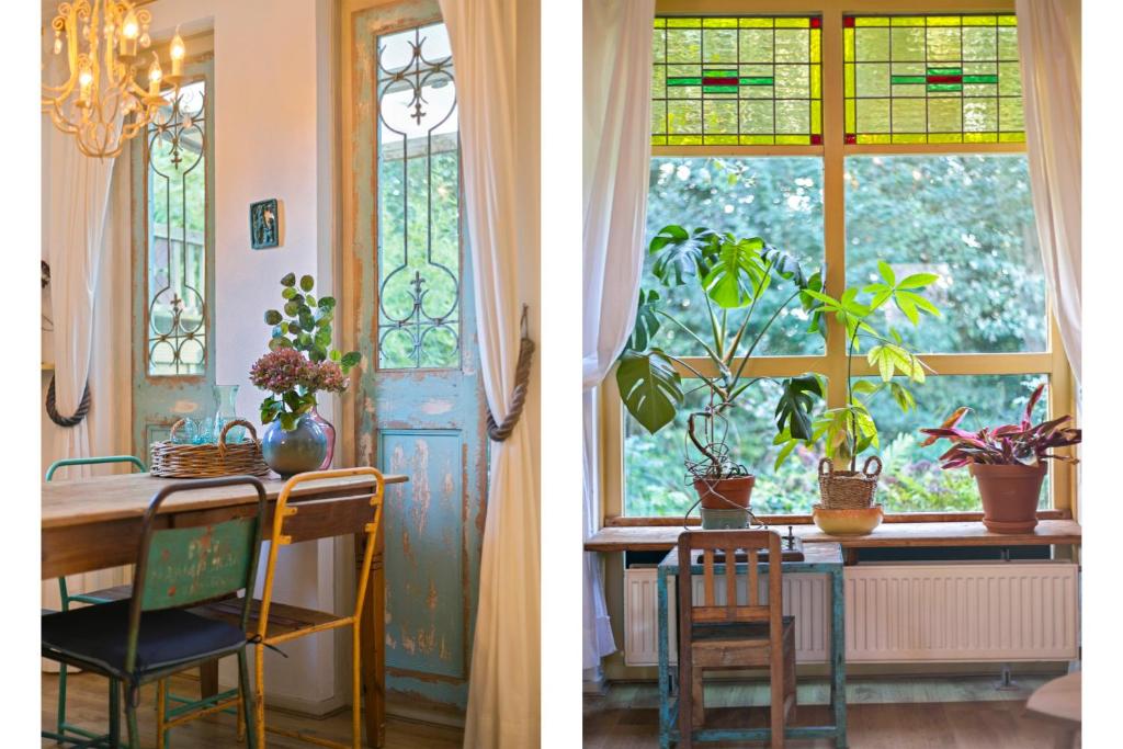 een eetkamer met een tafel en een raam met planten bij Blauwe Lelie in Ewijk