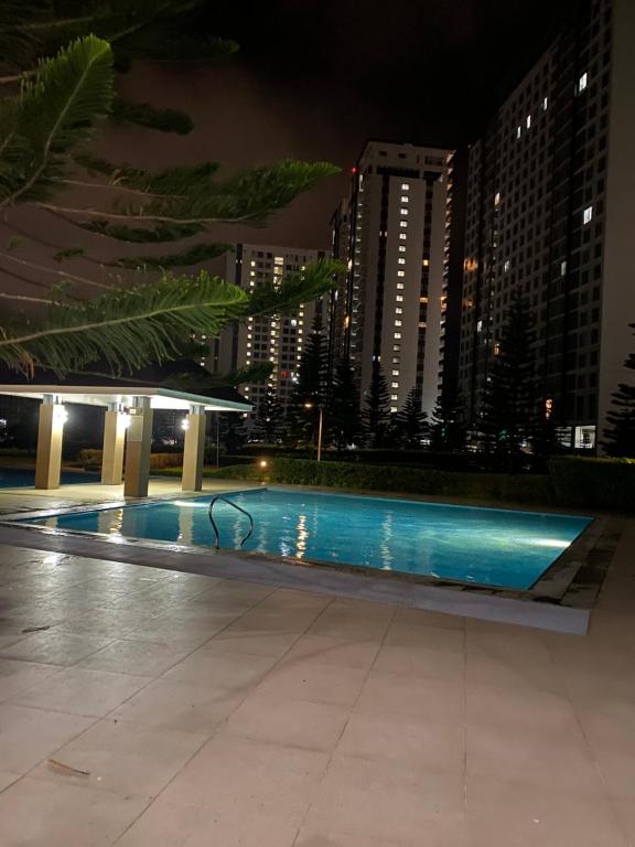 a swimming pool in the middle of a city at night at Wind Residences in Tagaytay