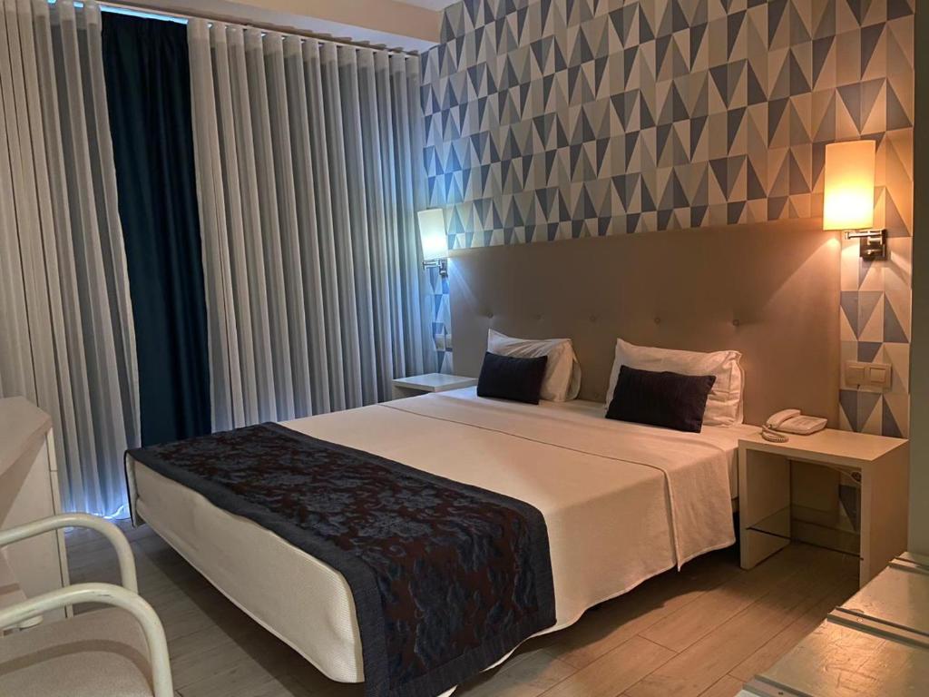 Postel nebo postele na pokoji v ubytování Ouril Hotel Julia