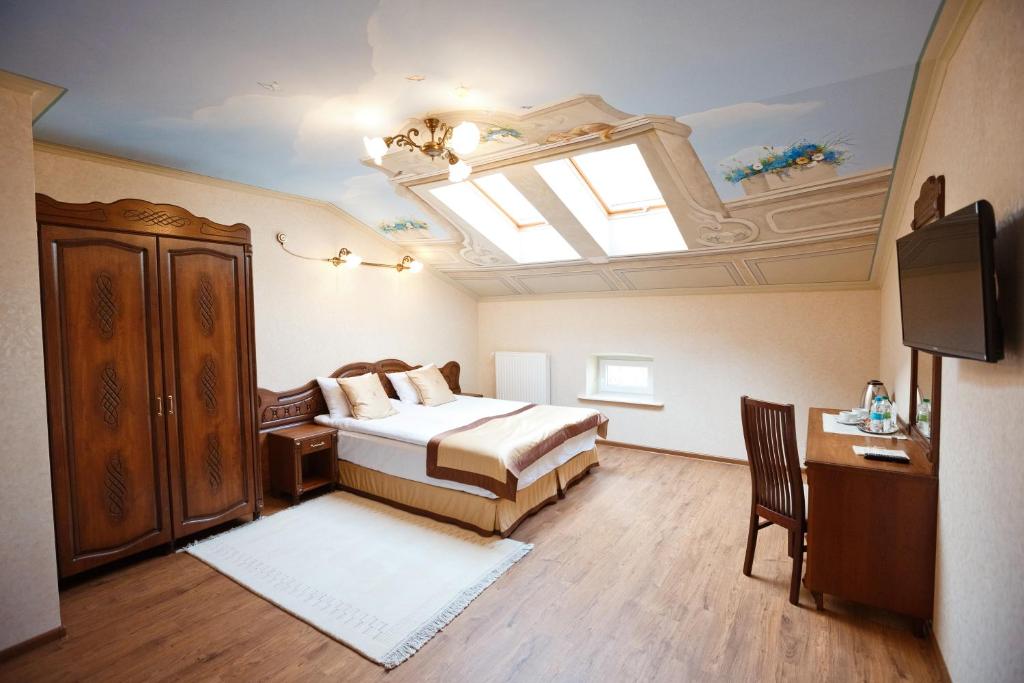 Ένα ή περισσότερα κρεβάτια σε δωμάτιο στο Mini-Hotel Guest House Inn Lviv