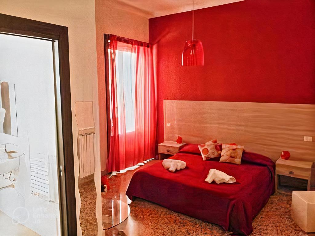a red bedroom with two dogs laying on a bed at Il Quadrifoglio Room& Suite in Palermo