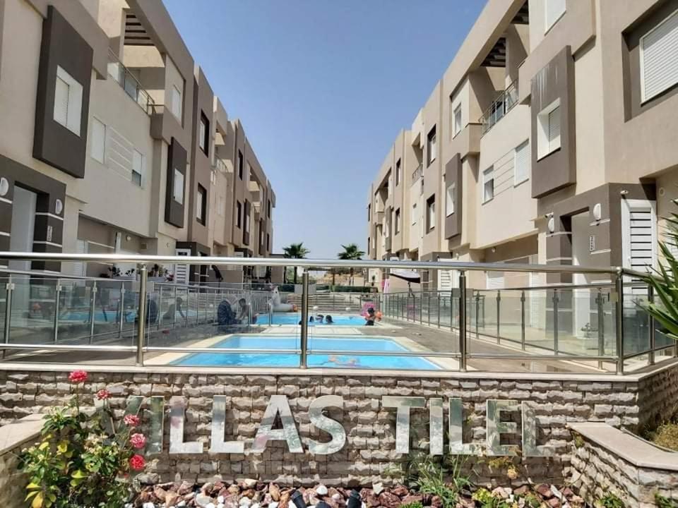 a view of an apartment complex with a swimming pool at VILLA TILEL AYADI Ridha in El Ahmar