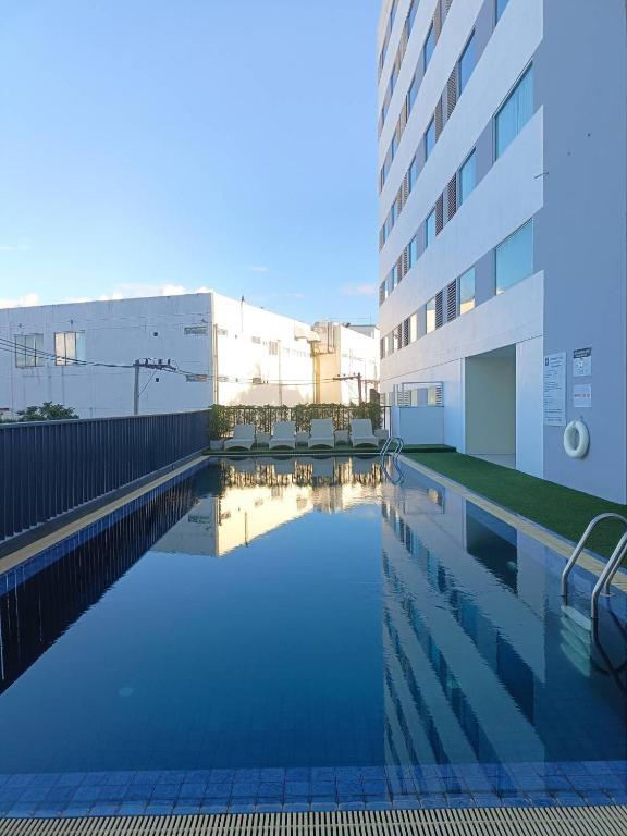 a swimming pool in front of a building at Star Hotel Chiang Mai in Chiang Mai