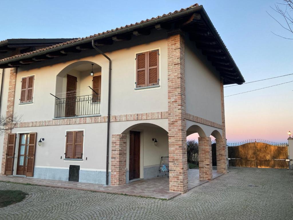 a large house with a balcony on a street at Casa vacanze Martina in Castagnole Lanze