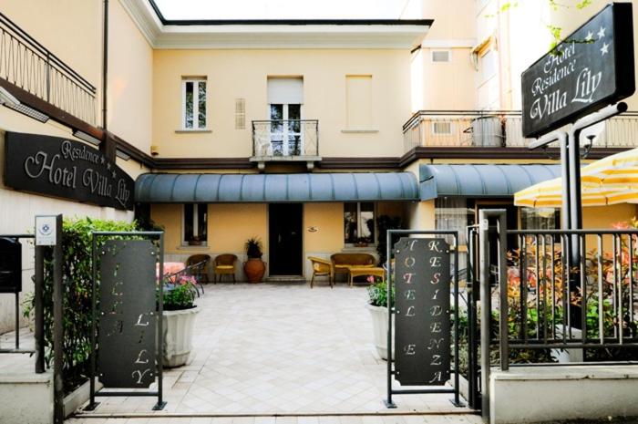 a building with a patio in front of a building at Hotel Residence Villa Lily in Cesenatico
