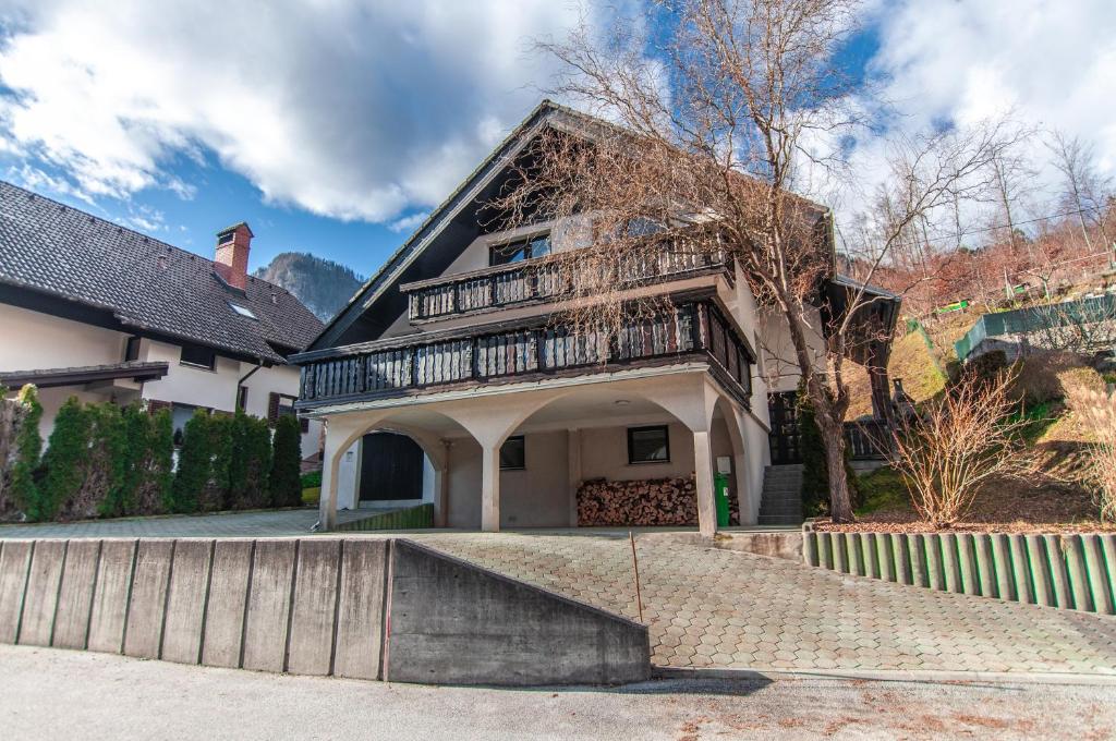a large house with a porch and a staircase at Holiday Chalet near Bled 