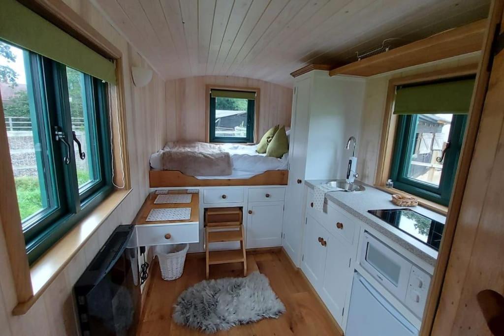 a tiny house with a sink and a desk in it at Penelope in West Chiltington