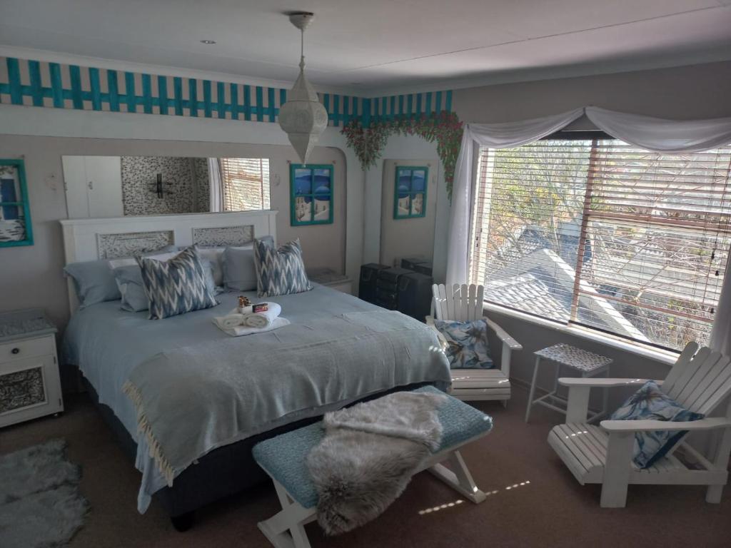 a bedroom with a bed and a large window at LISA VILLAGE in Bloemfontein