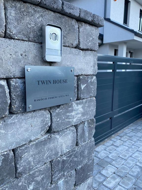 a sign on the side of a house on a brick wall at TWIN HOUSE in Gyál