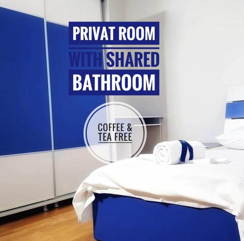 a room with a bed with a sign that reads twitch room with shared bathroom at Bus Station Hostel in Pristina