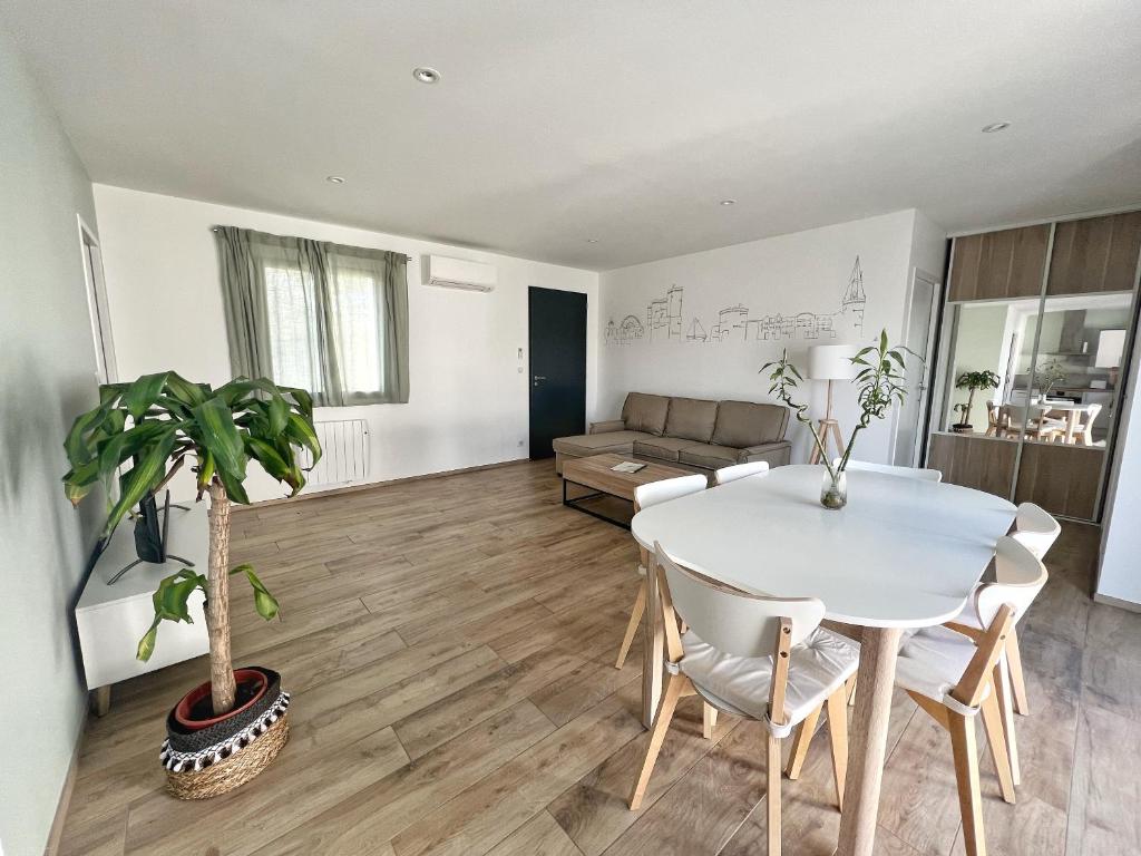 sala de estar con mesa blanca y sofá en Le Prieuré, en La Rochelle
