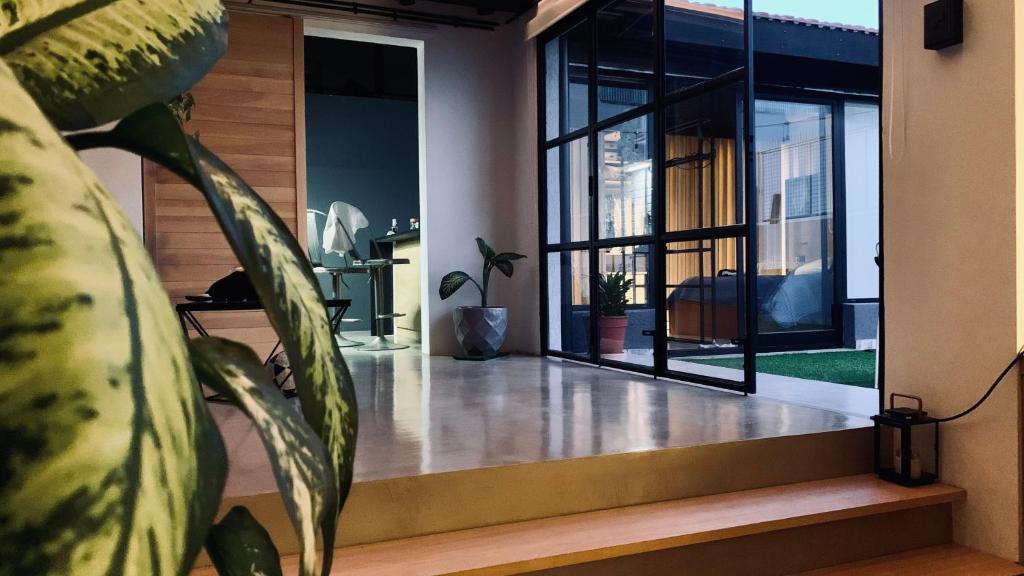 a house with glass doors and a plant at Cocoloft de Diseño in Buenos Aires