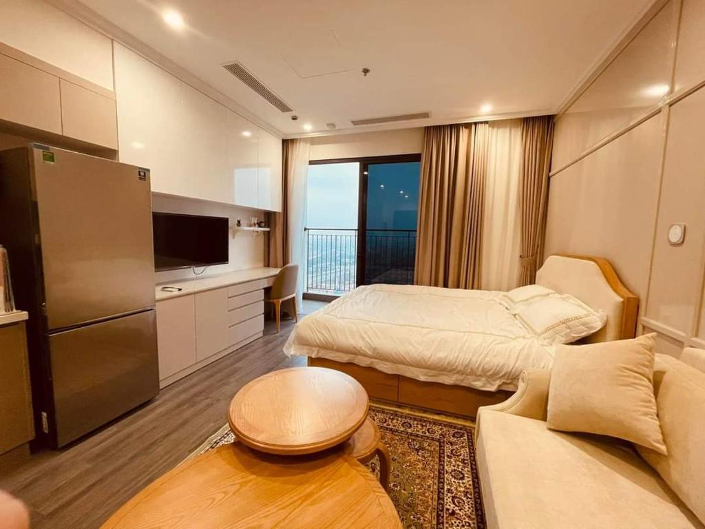 a room with two beds and a kitchen with a balcony at NK#Homestay#Vinhomes#Oceanpark#1PN#C6 in Gia Lâm Pho