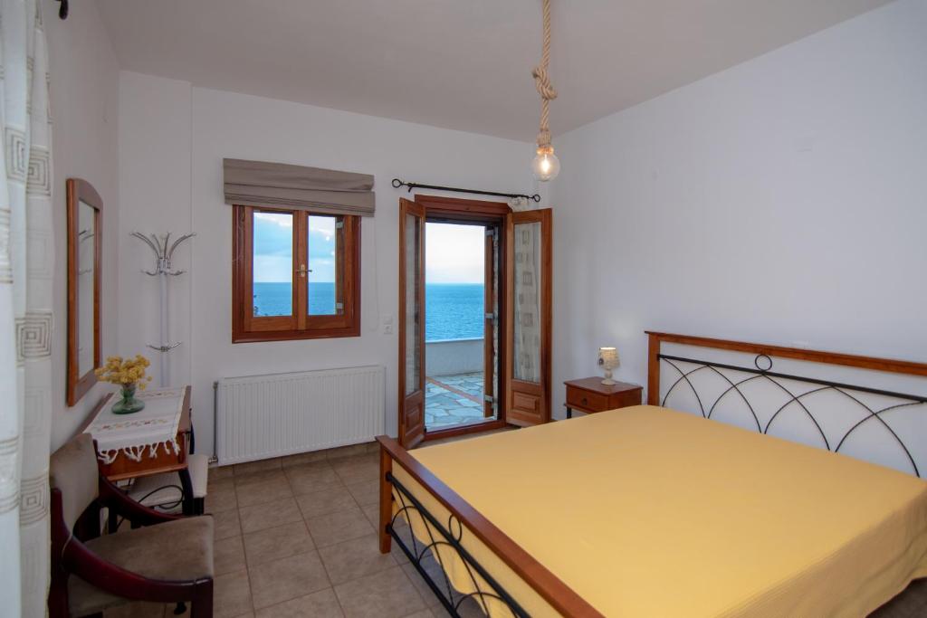 a bedroom with a bed and a view of the ocean at Potami Mountain in Karlovasi