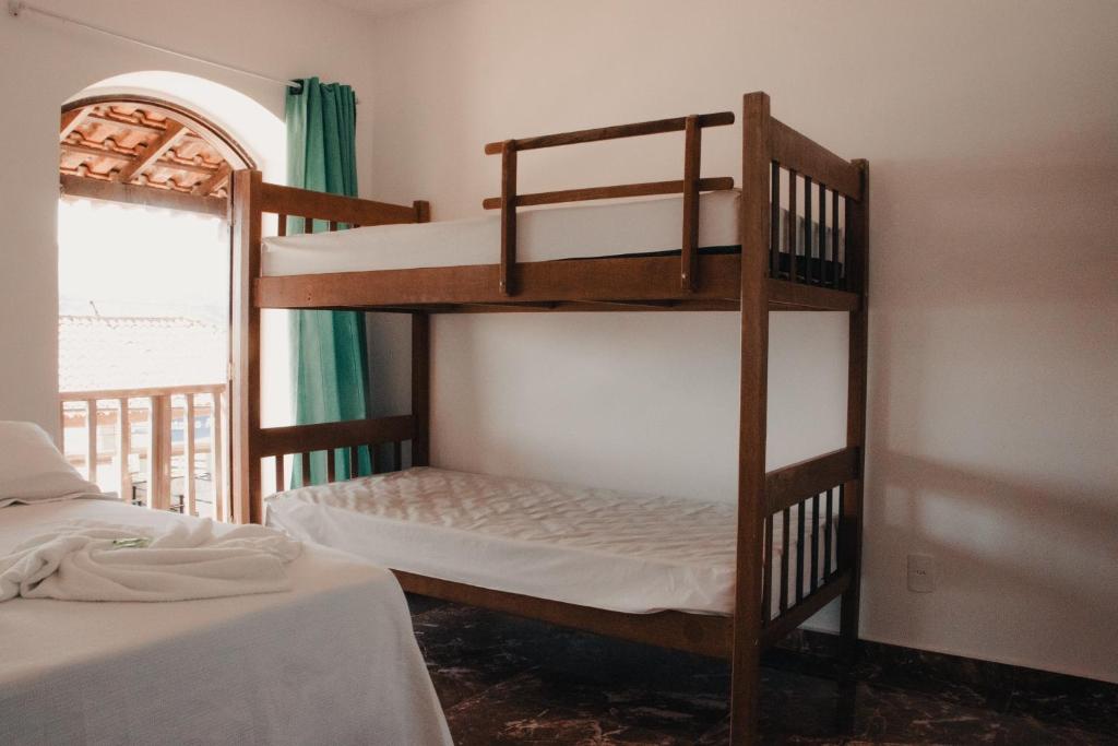 1 dormitorio con 2 literas y ventana en Beira Mar Hostel & Suítes, en Abraão