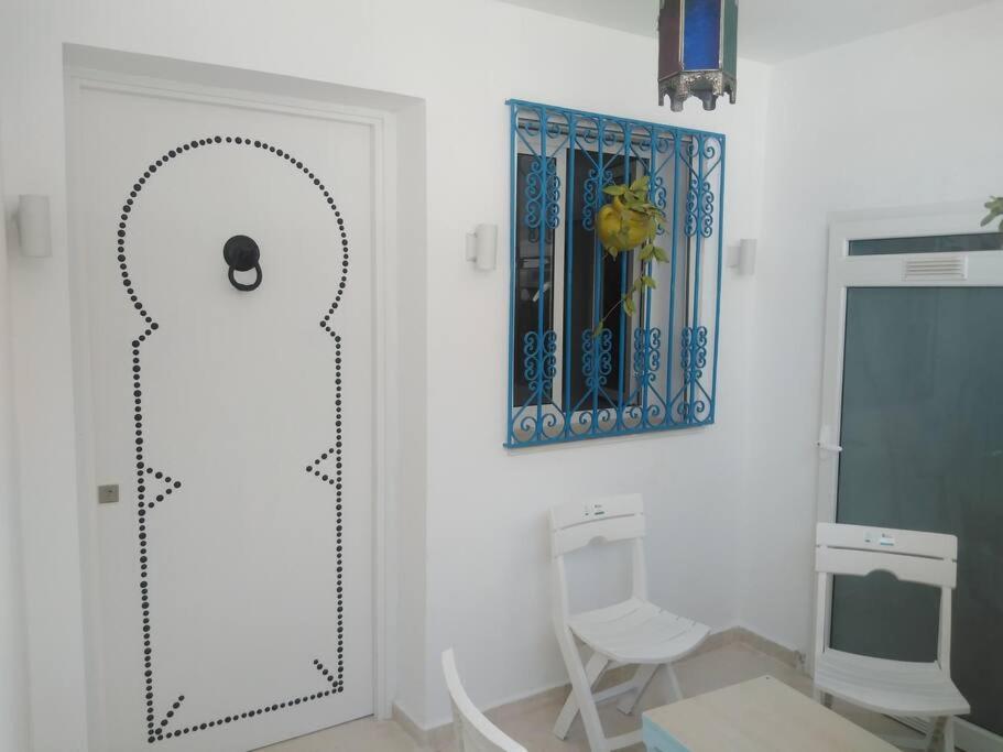 a bathroom with a mirror and two chairs and a toilet at Cosy Appartement in "Sidi Bou Said" in Sidi Bou Saïd