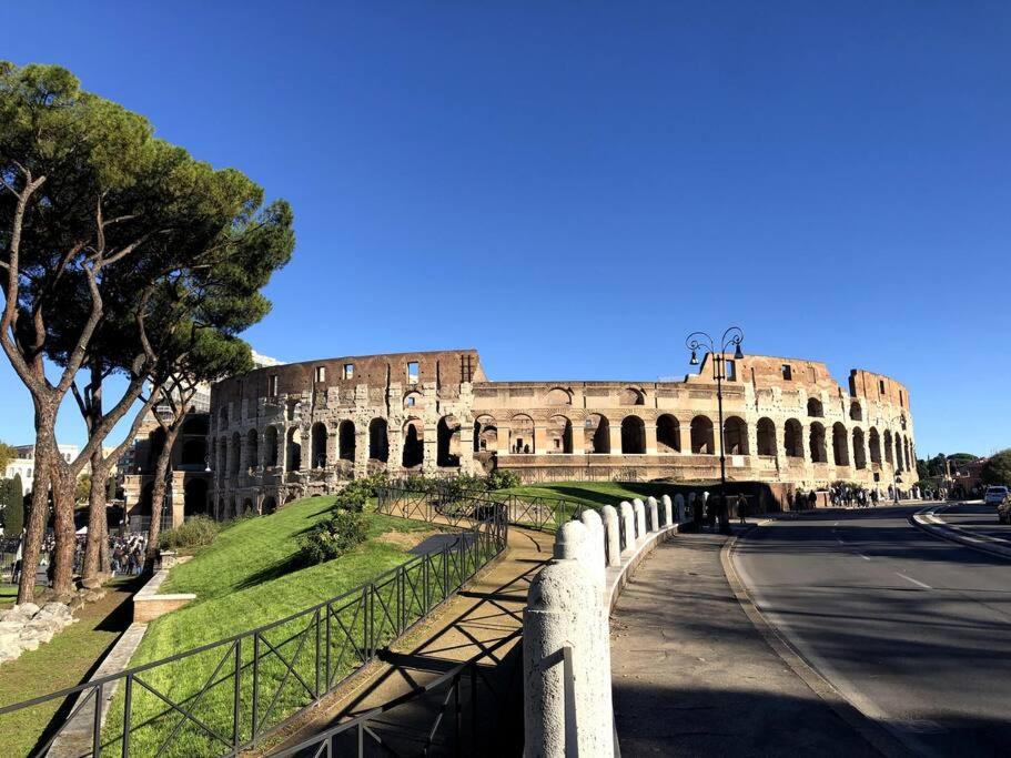 a view of the coliseum with a fence in front of it at Quiet & Cosy Colosseum in Rome
