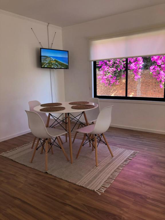 a dining room with a table and chairs at Casa Bulnes in Constitución