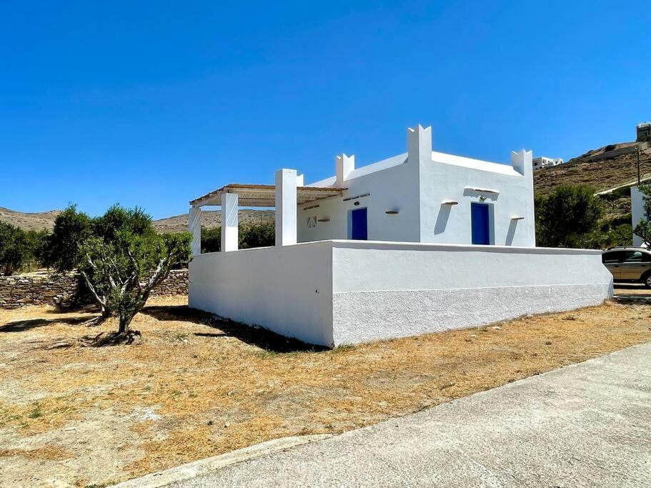 a white house in the middle of a field at Beach House in Ios Cyclades in Tzamaria