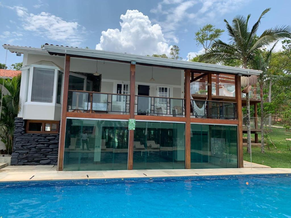 a large house with a swimming pool in front of it at POUSADA BELA VISTA in Pirenópolis