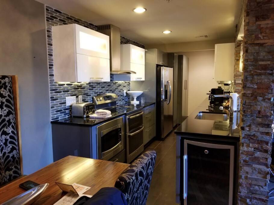 a kitchen with a wooden table and a counter top at Holiday Inn Desert Club Resort in Las Vegas