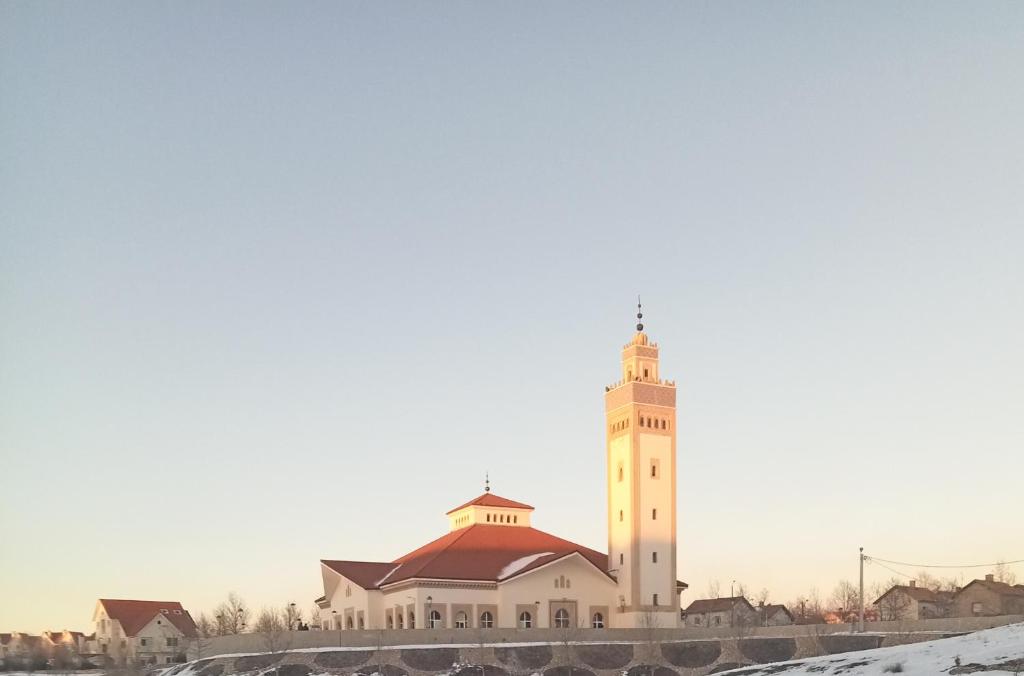 a large white building with a clock tower at Ifrane marhaba in Ifrane