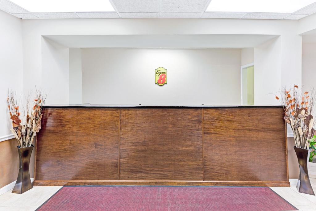 a large room with a large wooden wall at Super 8 Carrollton in Carrollton