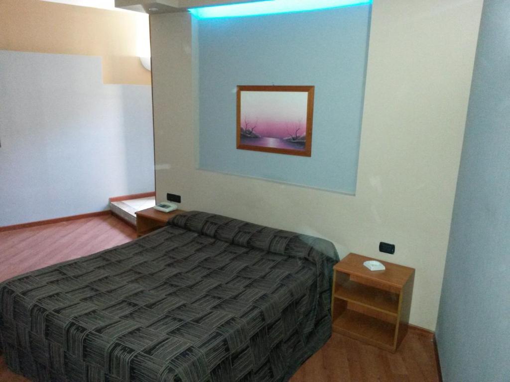 Letto o letti in una camera di Hotel Ginepro
