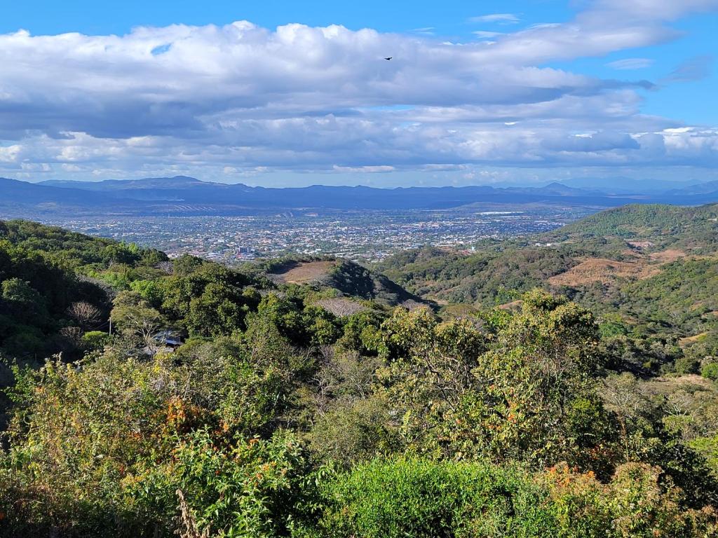 a view of a city from a hill with trees at Lantana in Estelí