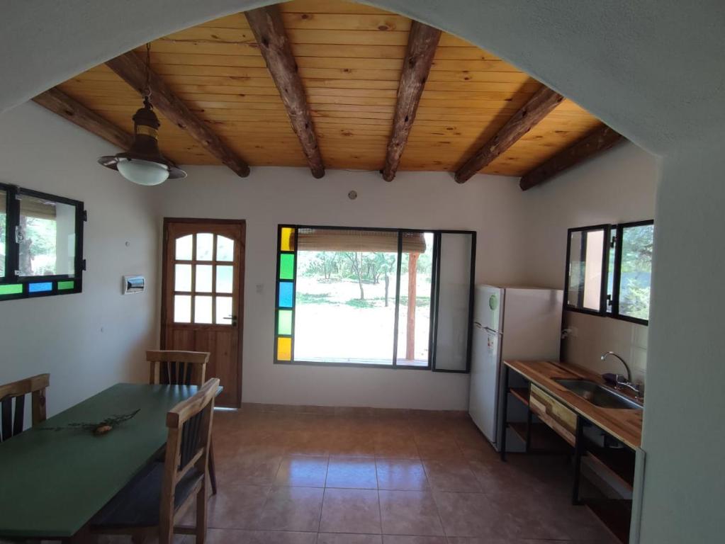 a kitchen with a table and a dining room at Saucearriba, Saucelinda. in Villa Dolores