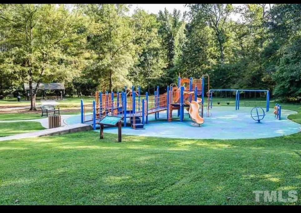 a playground in a park with a slide at Lovely 2 Bedroom Condo with Pool in Chapel Hill