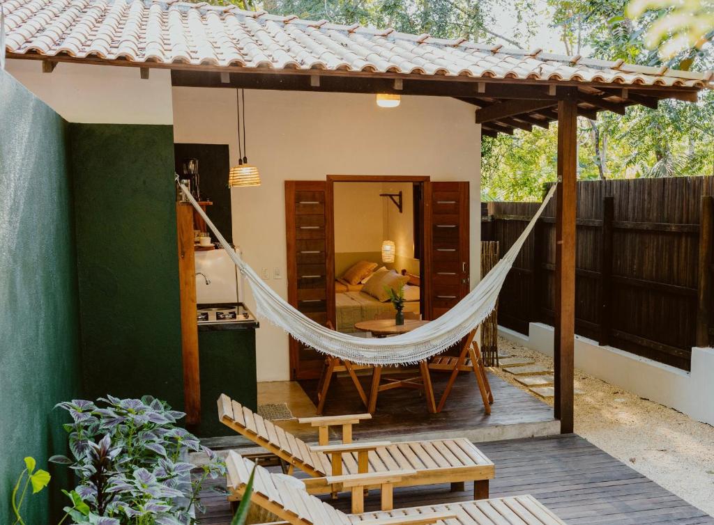 a hammock on the porch of a house at Recanto Alter do Chão in Alter do Chao