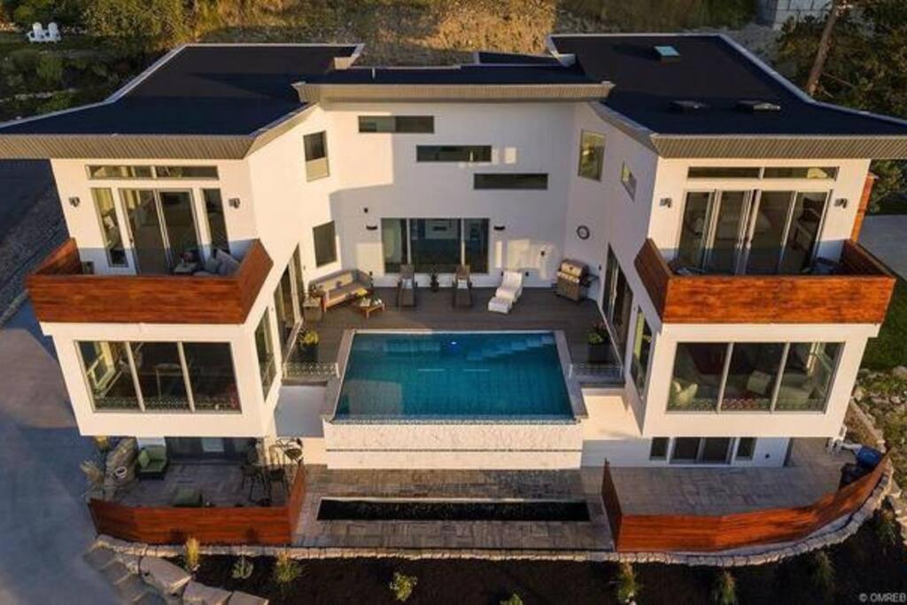 an aerial view of a house with a swimming pool at The Infiniti Villa in Kelowna