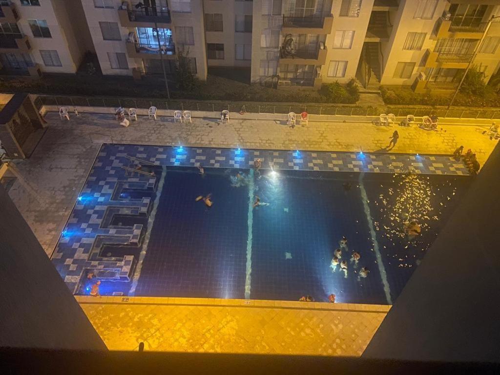 an overhead view of a swimming pool at night at Apartamento en hacienda peñalisa mango, Ricaurte in Ricaurte