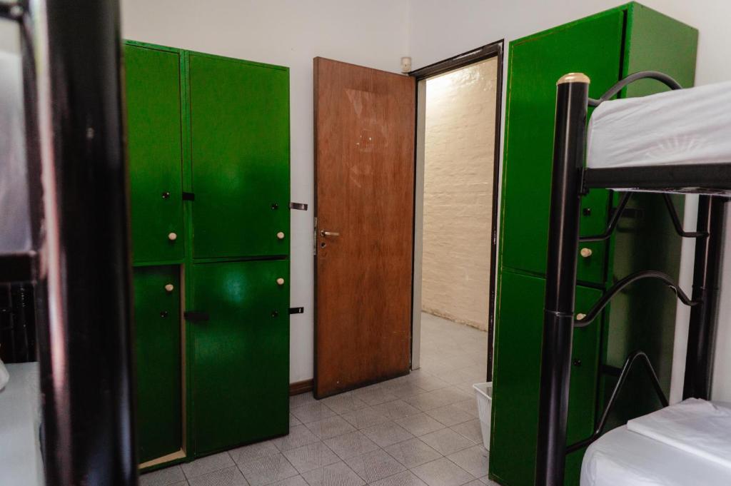 Pokój z zielonymi szafkami i łóżkiem piętrowym w obiekcie Clover Hostel w mieście Mendoza