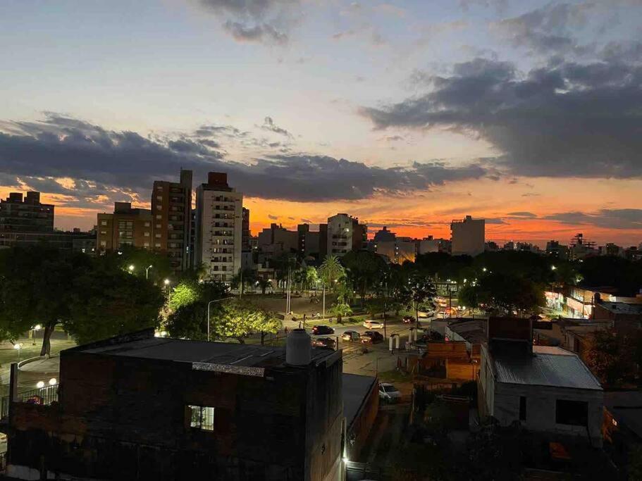 une ligne d'horizon au coucher du soleil avec des voitures dans une ville dans l'établissement Excelente apartamento equipado céntrico, à Corrientes