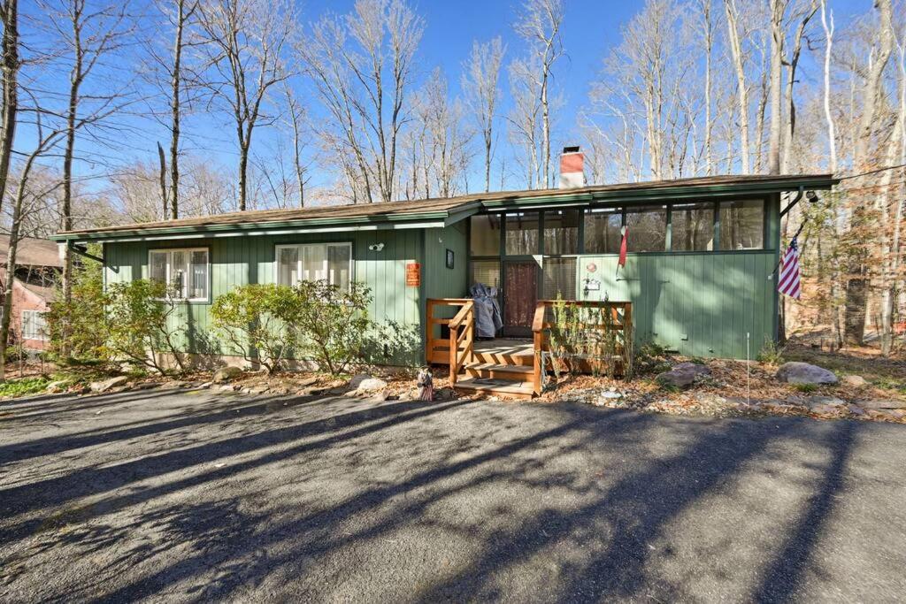 a green house on the side of a road at Pocono Pines, Lake Naomi 4 bedrooms, 2 full bath in Pocono Pines