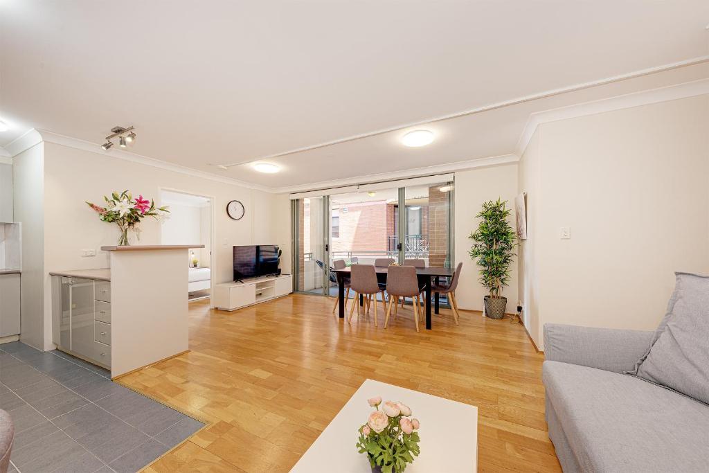 a living room with a couch and a table at Spacious & Cosy 2 Bedroom Apartment in Darling Harbour in Sydney