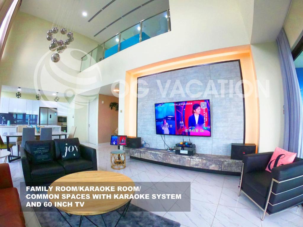 a living room with a large flat screen tv on a wall at Lovely 3-bedrooms with Karaoke Genting Penthouse in Genting Highlands