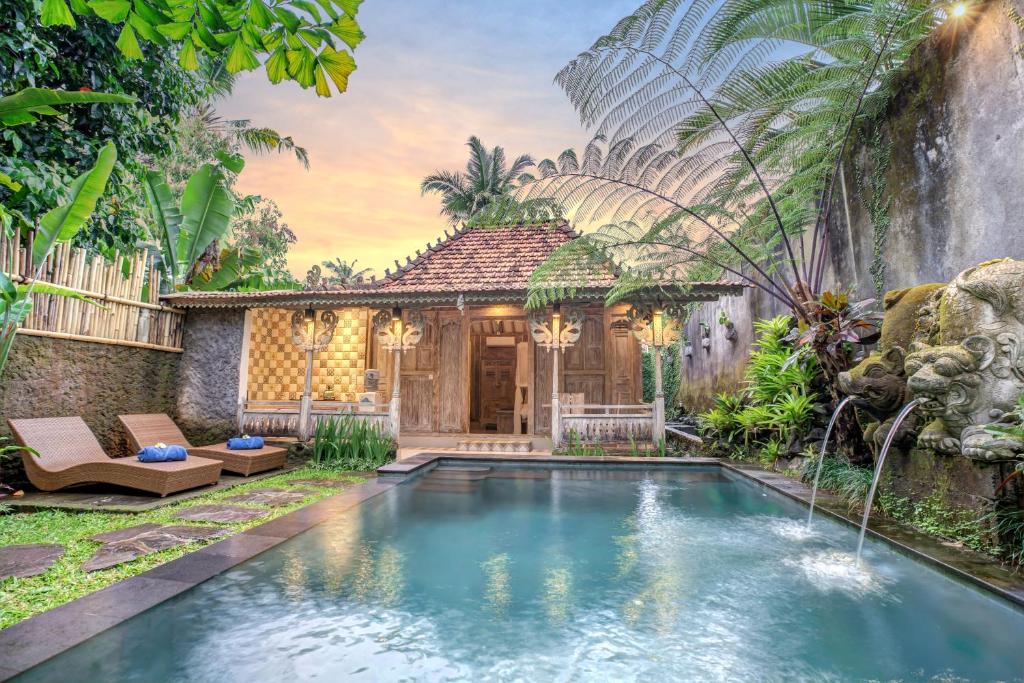 a pool in the backyard of a villa at Pratiwi Ubud Villa in Ubud
