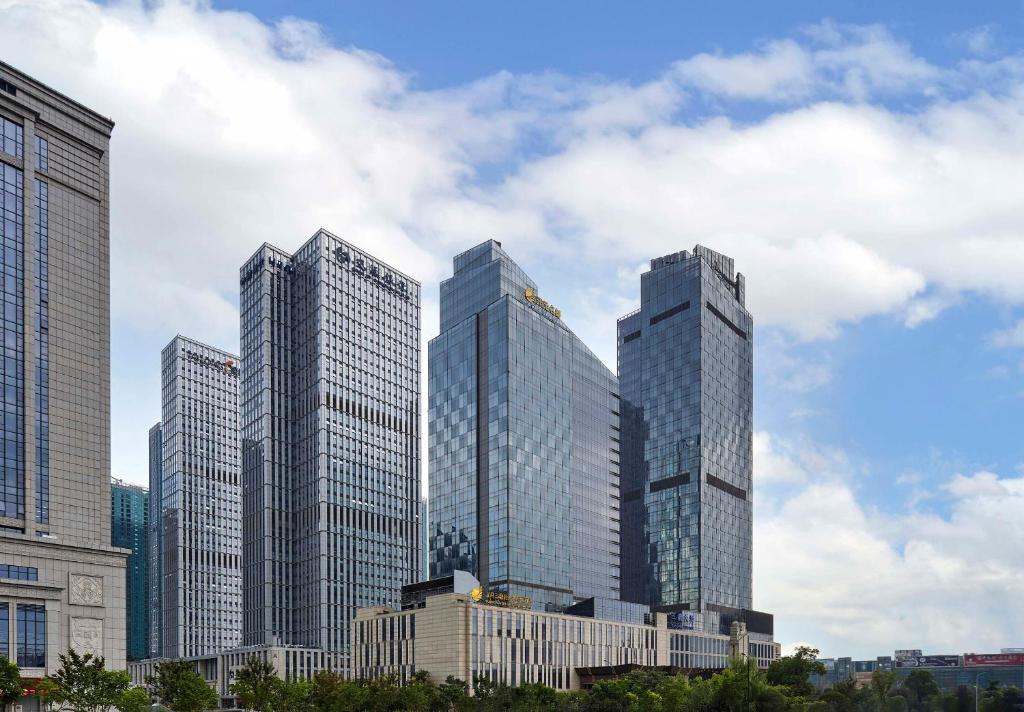 a group of tall buildings in a city at Sanding New Century Grand Hotel Yiwu in Yiwu