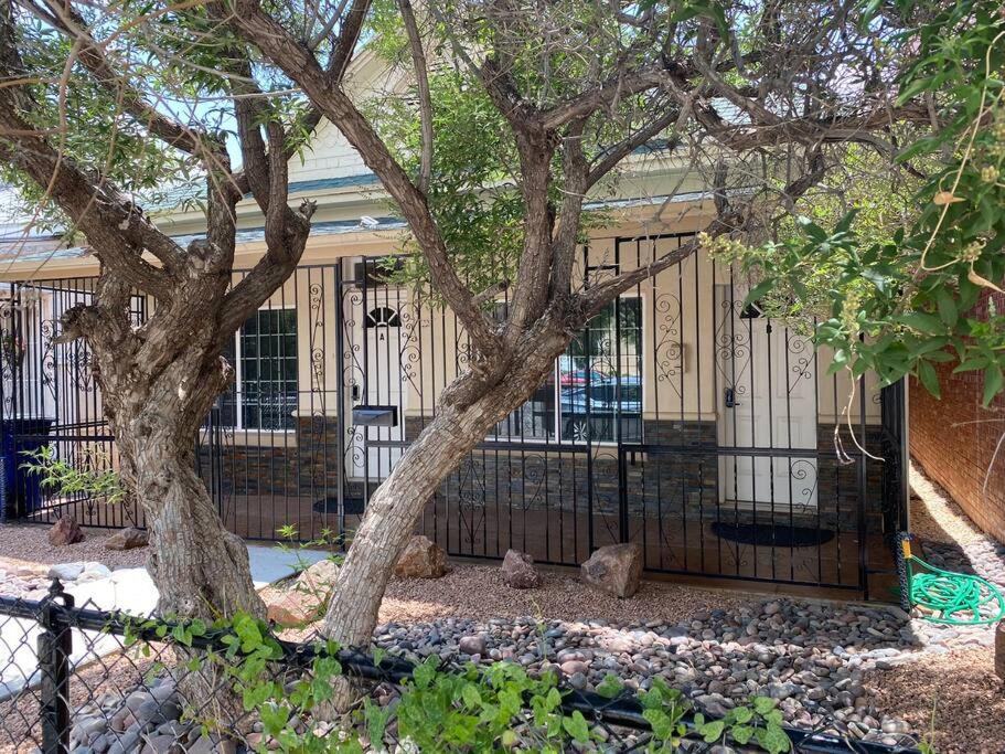 um edifício com um portão em frente a uma árvore em Big Family, Close to All, duplex A and B Downtown UTEP Hospitals em El Paso