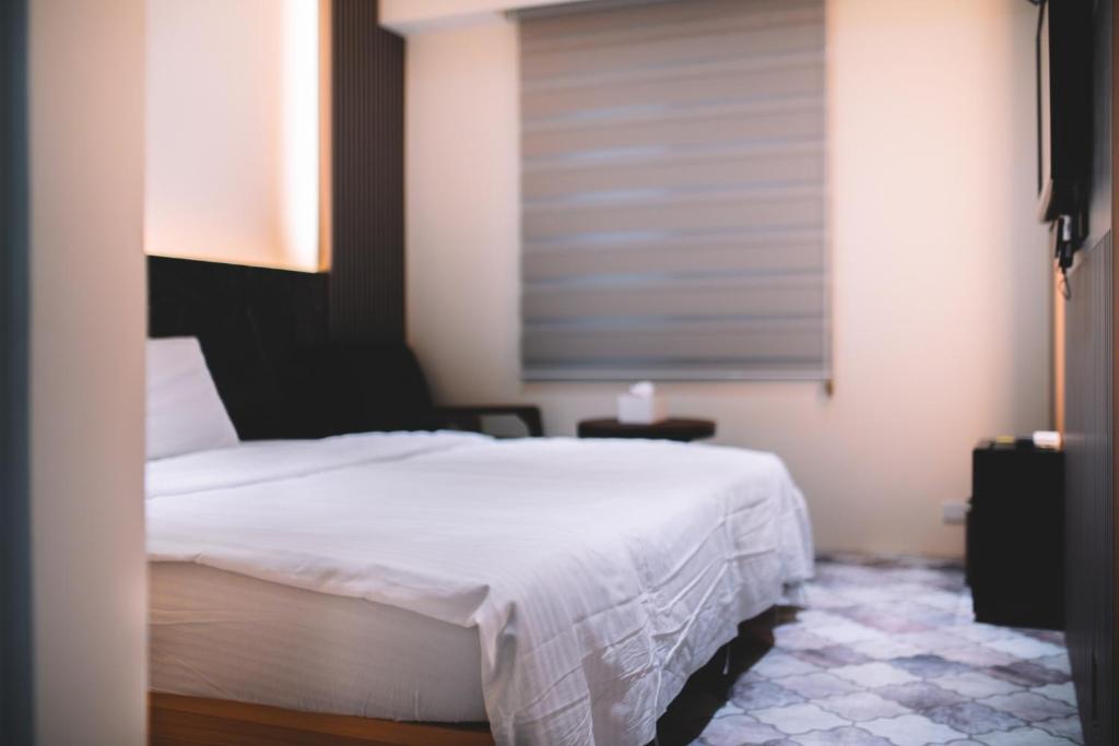 Postel nebo postele na pokoji v ubytování Xiaoliuqiu Ayana B&B