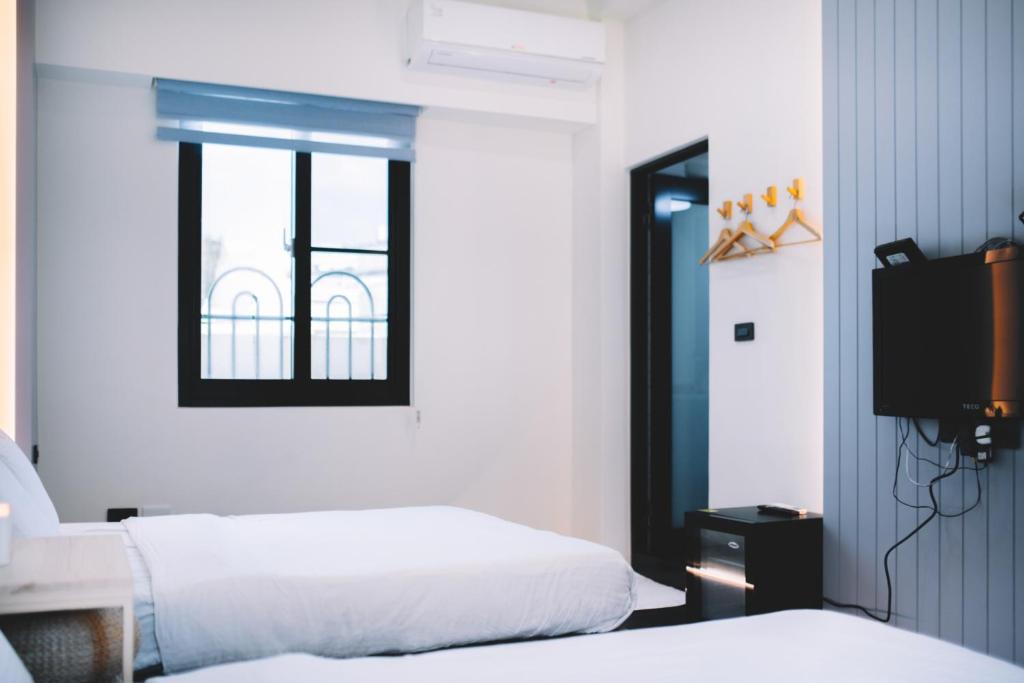 Postel nebo postele na pokoji v ubytování Xiaoliuqiu Ayana B&B