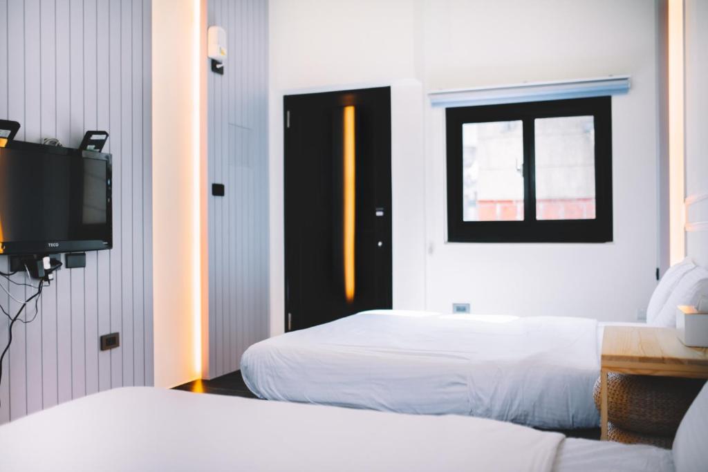 Postel nebo postele na pokoji v ubytování Xiaoliuqiu Ayana B&B